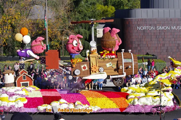 PASADENA, CALIFORNIA, USA - JANUARY 2: The float, IF PIGS COULD FLY, is pictured as it passes by the Norton Simon Museum during the 123rd edition of the Tournament of Roses Parade held January 2, 2012