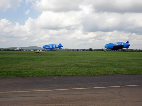 SOLBERG AIRPORT-READINGTON, NEW JERSEY, USA-SEPT 06: Seen attached to their mooring masts in 2012 are three blimps: DIRECTV, Horizon Blue Cross Blue Shield and, off in the distance, MetLife.