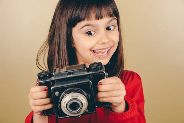 Funny little retro photographer girl