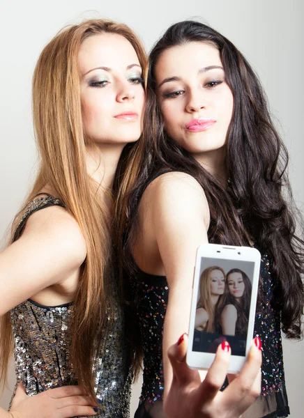 Beautiful girls making a self portrait with mobile