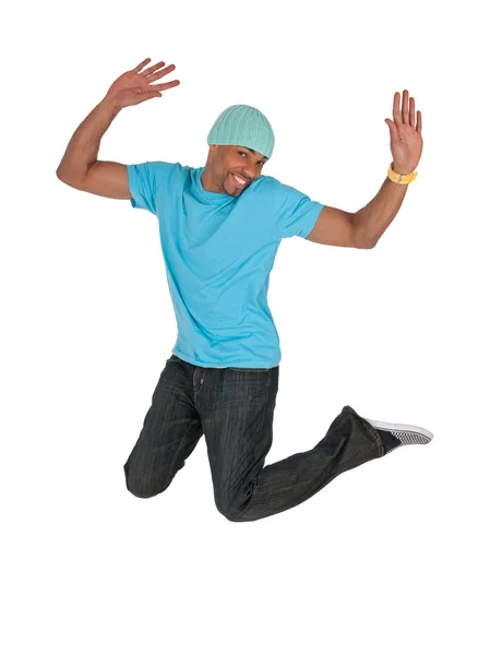 Smiling guy in a blue t-shirt jumping for joy