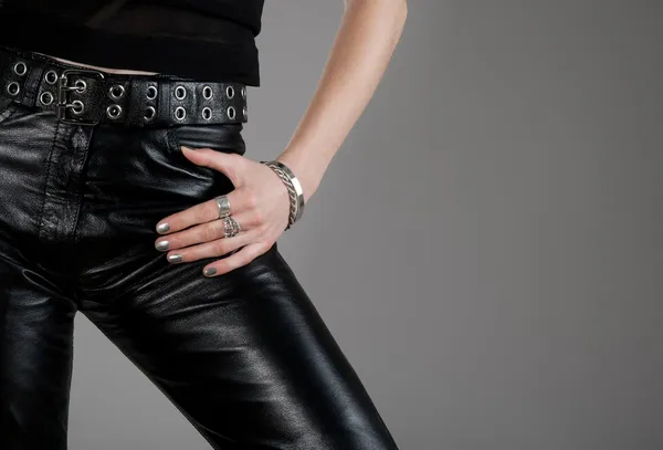 Leather pants and hand with silver jewellery