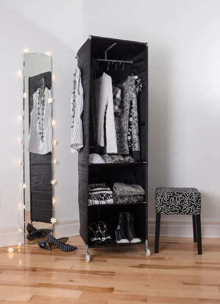 Mirror and mobile wardrobe with clothing