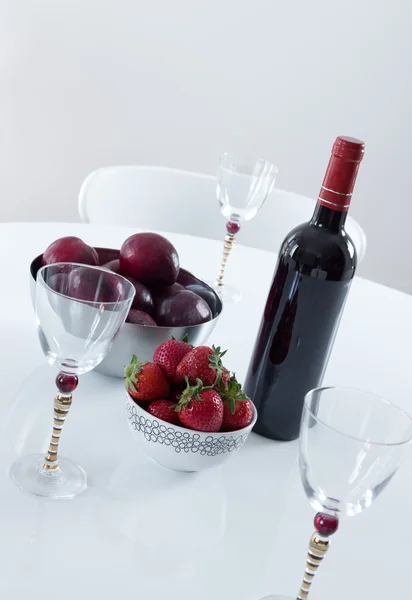 Red wine and fruits on a table