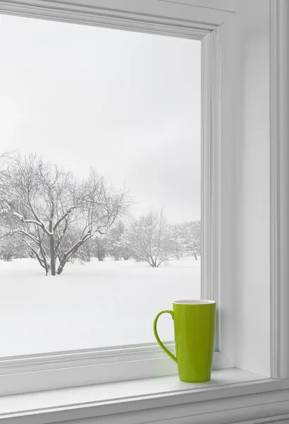 Green cup on a windowsill