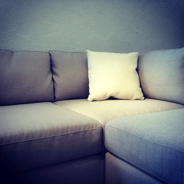 Corner sofa with white cushion