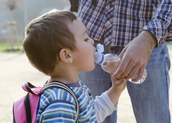 Child drinking water from a bottle