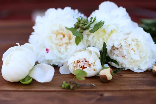 Peonies on wooden background