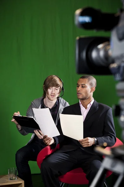 Floor Manager briefing Presenter in TV Studio