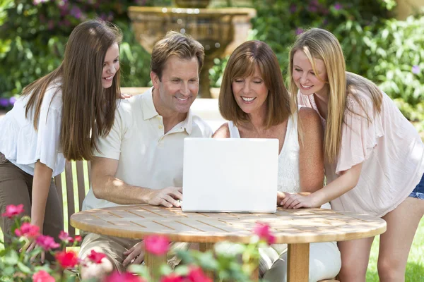 Family Using Laptop Computer Outside in Garden