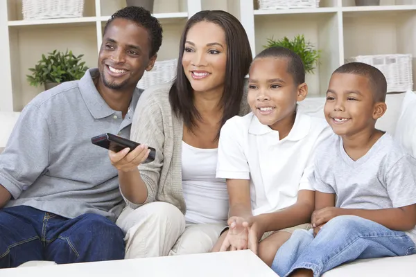 African American Family Watching Television With Remote Control