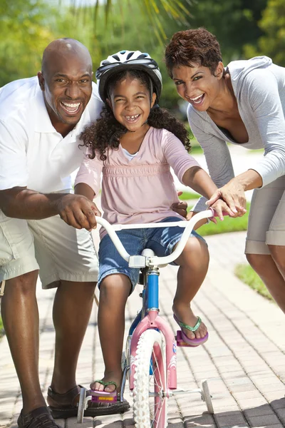 African American Family WIth Girl Riding Bike & Happy Parents