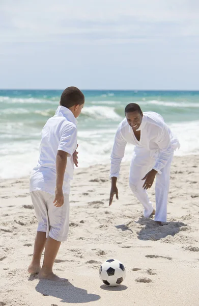African American Father & Son Playing Football Soccer on Beach