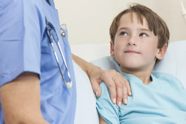 Doctor or Nurse Comforting Young Boy Child Patient