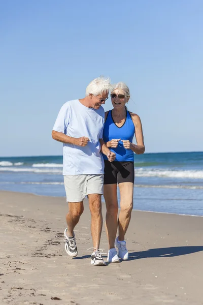 Healthy Senior Couple Running Jogging on Beach