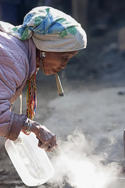 Unidentified  Hmong old woman smoking.