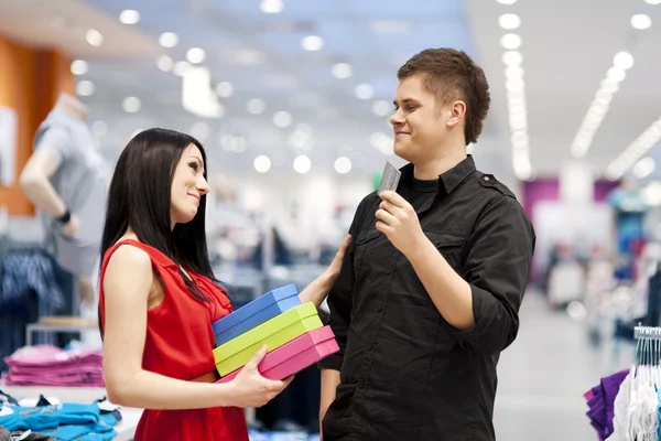 Man spoiling his girlfriend by buying her new clothes — Stock Photo #21825867