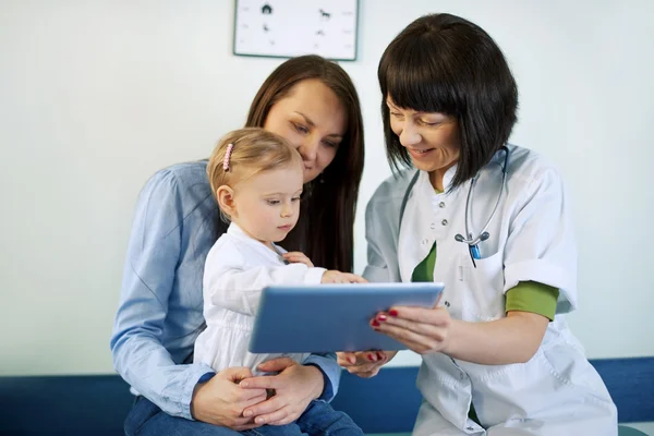 Doctor showing mother\'s medical results on the tablet