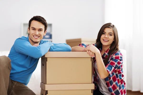 Portrait of young couple with moving boxes