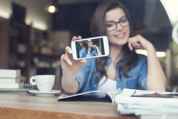 Attractive woman taking self portrait