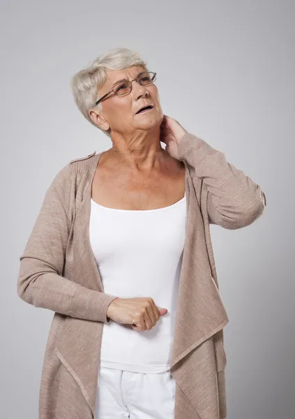Senior woman suffering from pain of neck