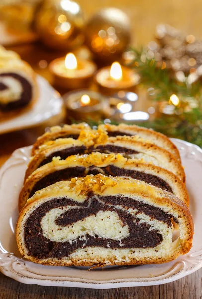 Poppy seed cake in golden christmas setting. Selective focus