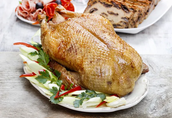 Baked duck on wooden table. Popular christmas dish