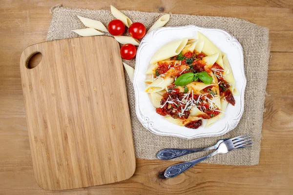 Top view of penne with dried tomatoes. Italian cuisine