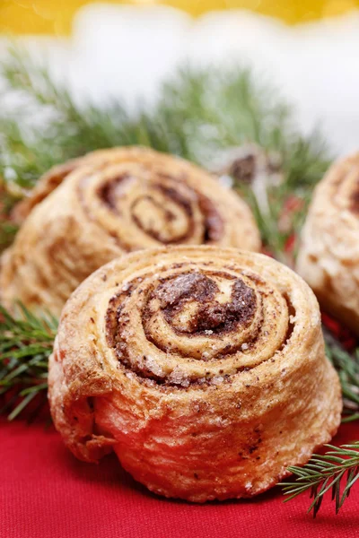 Delicious cinnamon rolls on christmas table. Selective focus