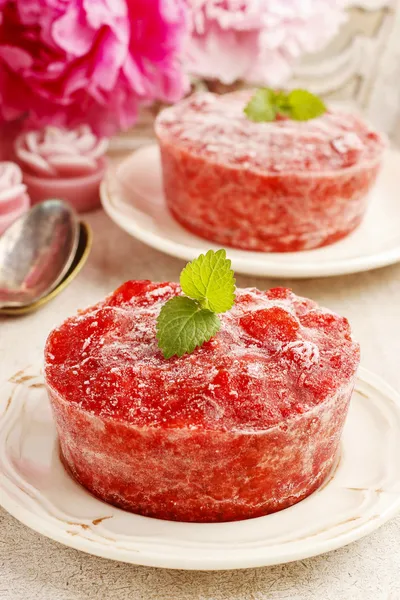 Strawberry sorbet decorated with mint leaf