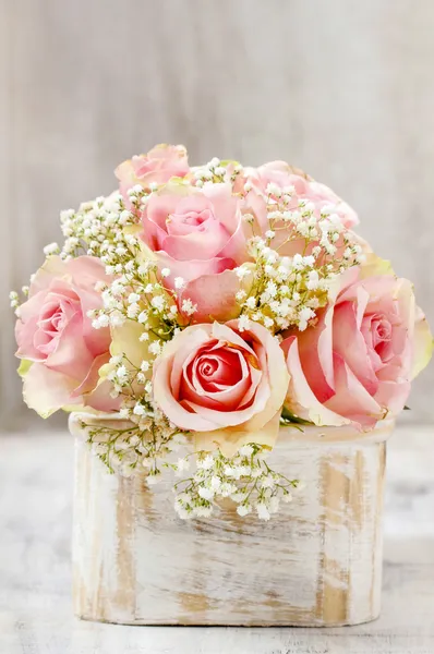 Bouquet of pink roses in wooden shabby chic box. Copy space