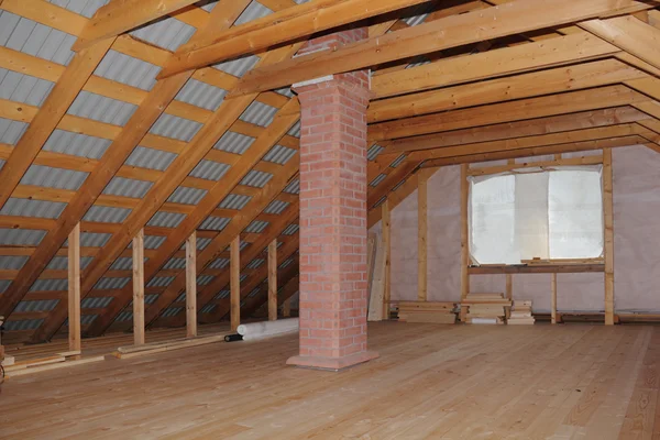 Attic with chimney in wooden house under construction