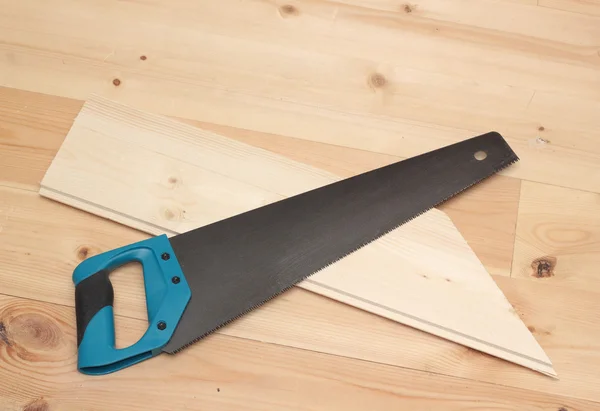 Hand saw and cutted deal board