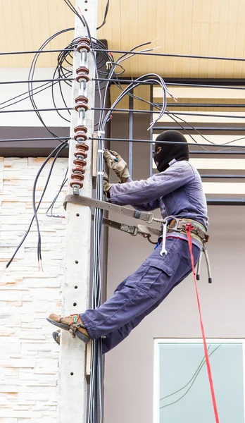 Electrician working on a pole