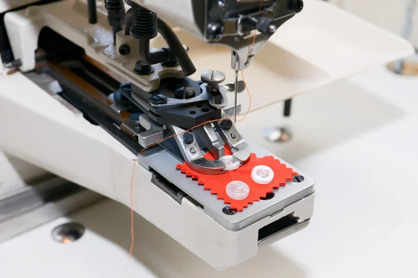 Machine for sewing on buttons of electric type