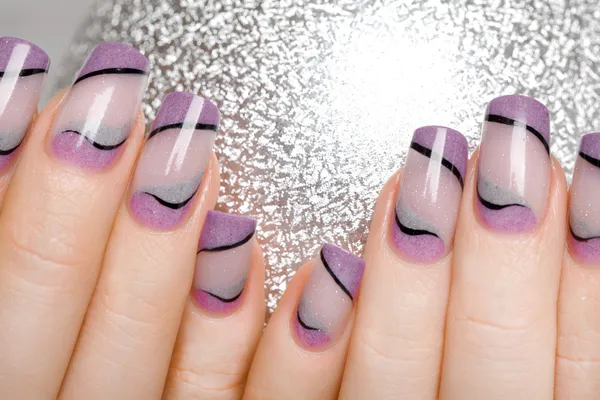 Female hands with beautiful manicure in gentle tones.