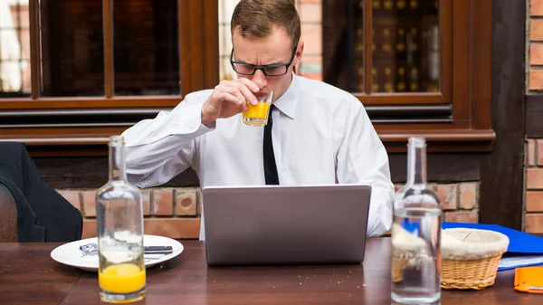 Working businessman drinking juice