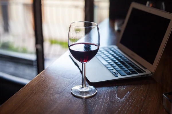 Wine glass and laptop