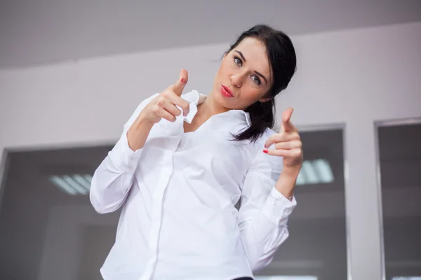 Businesswoman pointing at camera