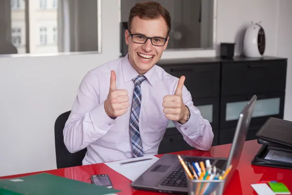 Businessman showing thumbs up