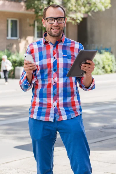 Man with mobile phone and digital tablet