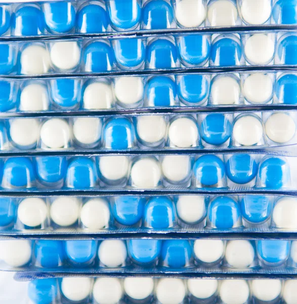 Layer of white and blue capsule in blister pack