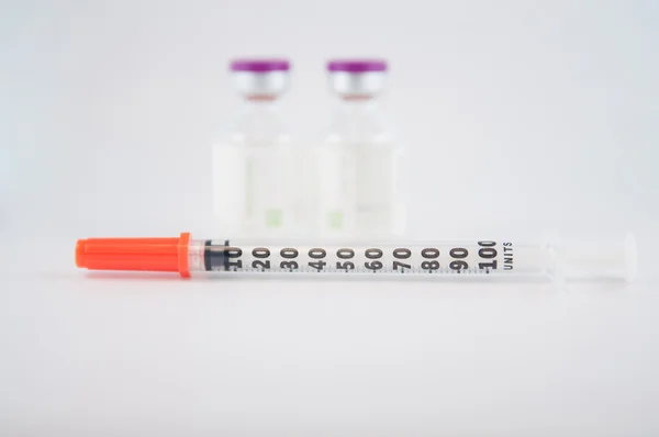 Dispoable syringe and Purple cap of medicine injection vial