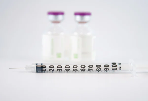 Disposable syringe on injection vials