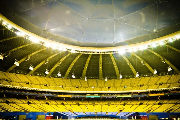 Empty stadium with yellow and blue seats