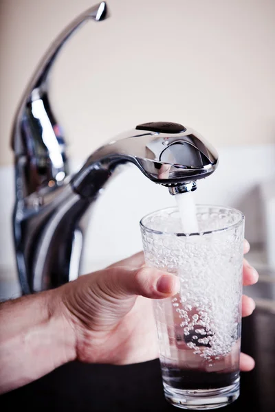 Thirsty man filling a big glass of water — Stock Photo #23713459