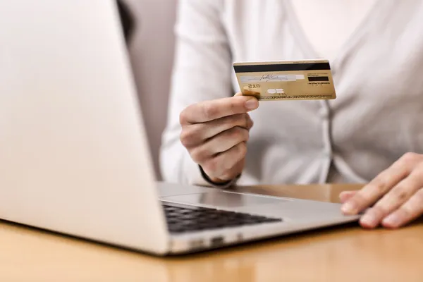 Close-up woman\'s hands holding a credit card