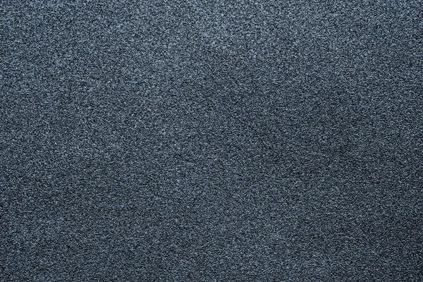 Fine-grained texture of a gray abrasive material