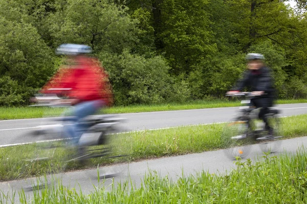 Active family riding bicycle in spring