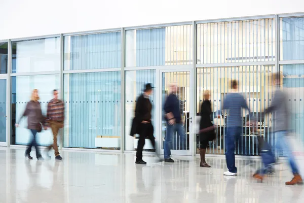 Unrecognizable People Walking in Modern Corridor